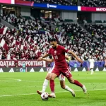 Qatar national team in maroon jerseys during international match